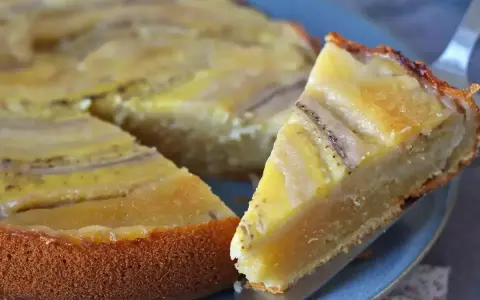 Un delicioso bizcocho de plátano, con trozos de fruta dorados y una base esponjosa, listo para ser disfrutado.