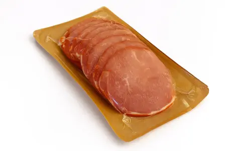 Lonchas de lomo adobado envasadas al vacío sobre una bandeja dorada.