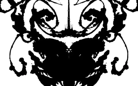 Symetryczna plama tuszu, przypominająca twarz lub zwierzę, używana w testach psychologicznych.