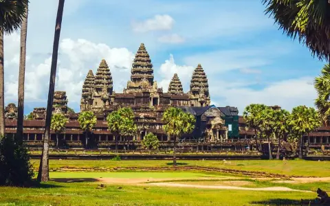 Angkor Wat, Cambodia, a majestic temple complex, bathed in sunlight. A gay couple enjoys the view, embracing the beauty of this historic site.