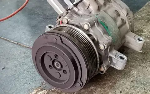 A car's AC compressor, a key component for cool air. Considering the ac compressor replacement cost? This part is vital for your comfort.