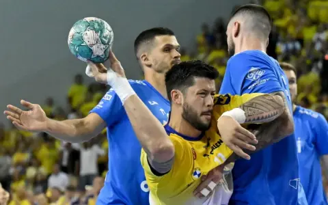 Nicolas Tournat w akcji, walczy o piłkę w meczu piłki ręcznej.