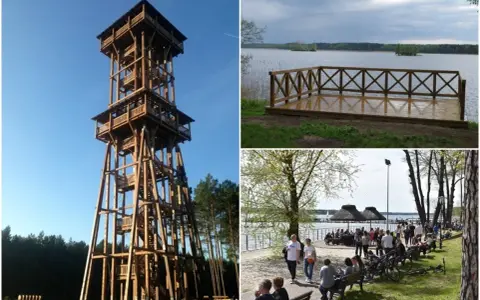 Wysoka, drewniana wieża widokowa Joanna góruje nad lasem. Obok jezioro z pomostem i plaża z ludźmi.