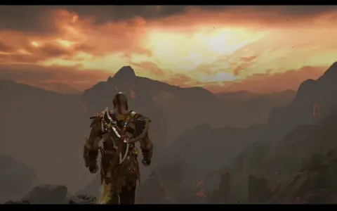 Kratos, el dios de la guerra, contempla el paisaje infernal de Muspelheim bajo un cielo ardiente.