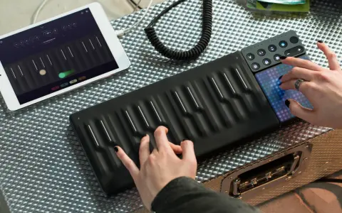 Tworzenie muzyki instrumentalnej elektronicznej na nowoczesnym kontrolerze. Ręce grające na klawiszach i dotykowe pady.