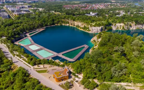 Widok z lotu ptaka na zalew Zakrzówek z drewnianymi pomostami i basenami. Trasa spacerowa wokół zbiornika.