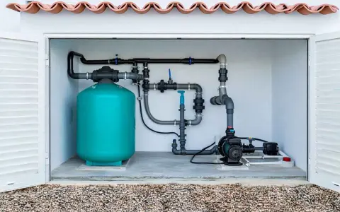 Système de filtration de piscine compact, une solution locale pour une piscine de 2m². Tuyauterie, pompe et réservoir turquoise.