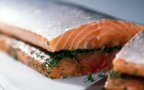 Närbild på gravad lax med dill, redo att serveras.