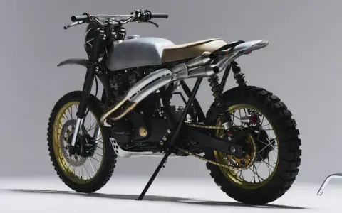 Stylowy motor scrambler z matowym, srebrnym bakiem, podwójnym wydechem i terenowymi oponami. Gotowy na przygodę!