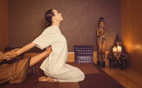 A woman receives a traditional Thai massage, a practice with a rich history rooted in ancient healing traditions.