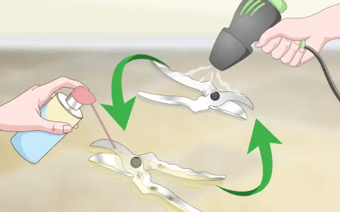 Hands spray lubricant onto pruning shears to remove rust. A heat gun is then used to dry them.