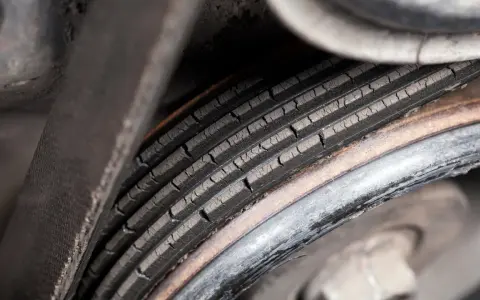 Cracked serpentine belt, a common cause of belt failure, shows signs of wear and tear.