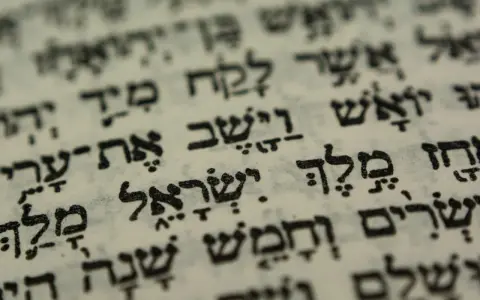 Close-up of Hebrew text on aged paper, hinting at the biblical meaning of Israel through ancient scripture.