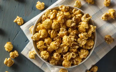 Miseczka karmelowego popcornu, idealna przekąska. Chcesz wiedzieć, jak zrobić popcorn? Oto inspiracja!