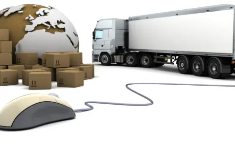 Globalne giełdy transportowe: stosy paczek, globus, ciężarówka i myszka komputerowa symbolizują łatwość zamawiania transportu online.