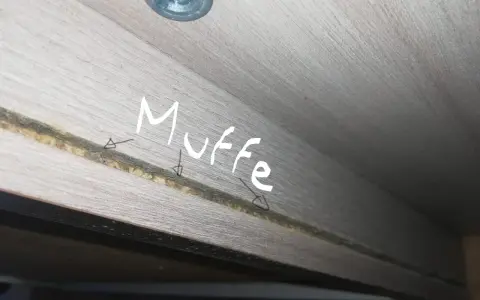 Muffa negli armadi? Ecco come eliminarla. Dettaglio di una fessura in un mobile in legno con segni di muffa.