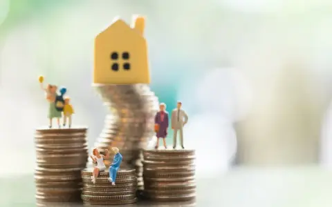 Miniaturowe figurki ludzi i domku na stosach monet. Symbolizują różne modele rodziny, w tym rodzinę patchworkową, i ich sytuację finansową.