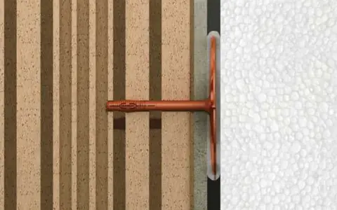 Cheville ite fixée dans un mur isolant en polystyrène expansé, montrant la fixation d'un élément sur une structure isolée.