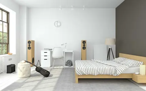 Pokój nastolatka inspiracje: łóżko, biurko, gitara i głośniki tworzą przestrzeń dla młodego muzyka.