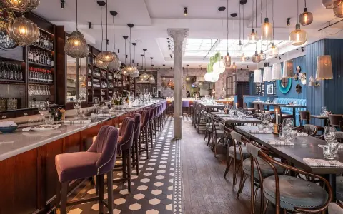 Elegant restaurang med bardisk, sammetsstolar och vackra lampor. Perfekt för en trevlig kväll, som många **sorellina recensioner** vittnar om.
