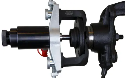Automotive hub bearing removal and installation tool with a black hydraulic cylinder and silver clamp.