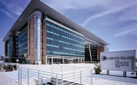 Modern hotel building with glass facade and a sign for Laguna Palace.