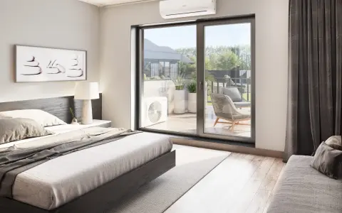 Unidad exterior de aire acondicionado visible a través de la puerta corredera, con una cama y arte de pared en la habitación.