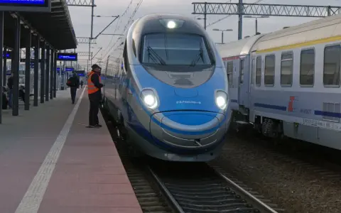 Pendolino Warszawa-Kraków na peronie. Maszynista w kamizelce odblaskowej czeka na pasażerów.