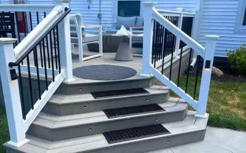 A beautifully lit deck staircase, showcasing how to build deck stairs with integrated lighting and non-slip mats.