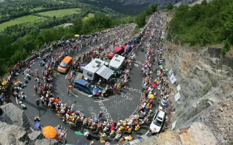 Spectators line the winding road of Alpe d'Huez for the Tour de France, a sea of color and anticipation.