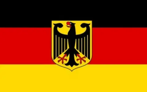 Flaga Niemiec z godłem orła. Symbolizuje zwrot podatku z Niemiec, który może przynieść korzyści.