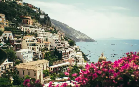 Positano, uno dei paesi più belli della Costiera Amalfitana, con case bianche aggrappate alla scogliera e il mare blu pieno di barche.