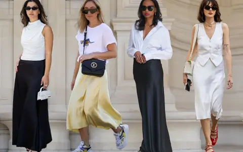 Four women in stylish outfits featuring satin skirts in black, yellow, and white.