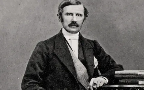 Johan August Gripenstedt, en framstående svensk politiker, porträtterad med mustasch och klädd i mörk kostym.