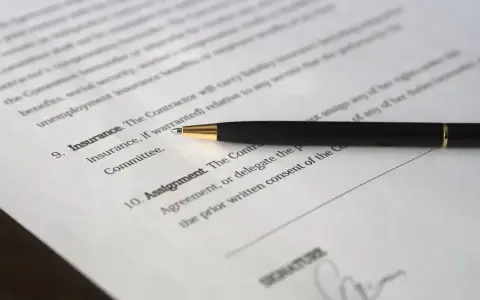 Długopis leży na dokumencie, gdzie widnieje nagłówek "umowa użyczenia lokalu" i miejsce na podpis.