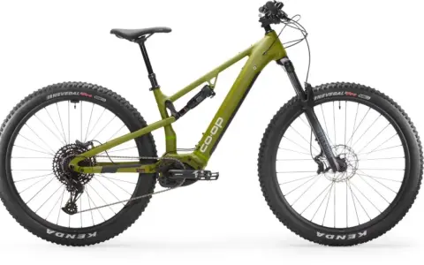 A green Co-op electric mountain bike, ready for a REI bike tune-up, with full suspension and knobby tires.