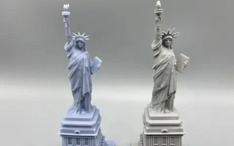 Two Statue of Liberty models: one smooth, likely resin vs. filament 3d printer with visible layer lines.