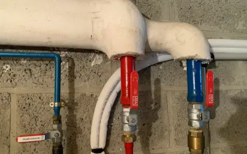 Système de chauffage avec tuyaux isolés. Une vanne marquée "REMPLISSAGE" est visible.