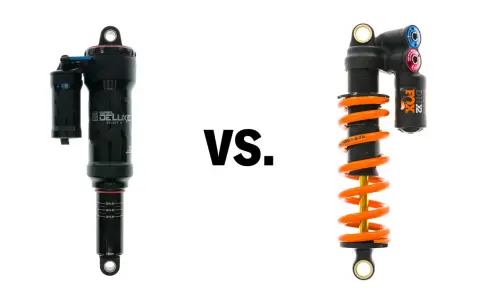 A black air shock and an orange coil shock are shown side-by-side, illustrating the coil vs air shock debate for mountain bikes.