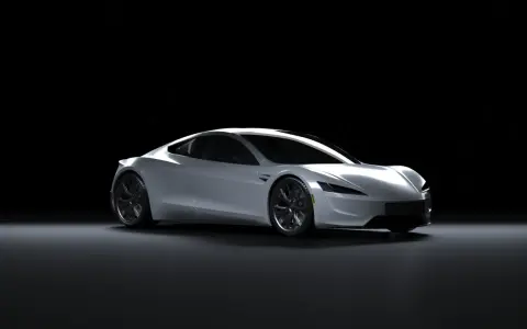 Srebrny Tesla Roadster na czarnym tle. Zastanawiasz się, ile kosztuje Tesla?
