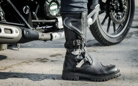 Czarne, skórzane buty motocyklowe z klamrami, idealne na każdą wyprawę. To właśnie takie buty na motocykl zapewnią komfort i bezpieczeństwo.