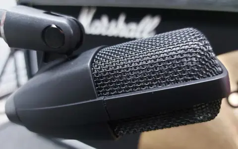 Mikrofon Sennheiser 421 na statywie, gotowy do nagrania rockowego brzmienia z głośnika Marshall.