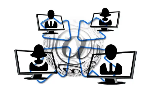 Vier Monitore mit Silhouetten von Personen, verbunden durch blaue Linien, umgeben von einem großen @-Symbol. Dies symbolisiert die Vernetzung und die Bedeutung von Online-Kommunikation, aber auch die Gefahr von "hijacking" – der Übernahme von Accounts.