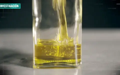 Aceite de oliva vertiéndose en un recipiente de vidrio. La investigación busca determinar cuántas veces se puede usar el aceite de oliva.