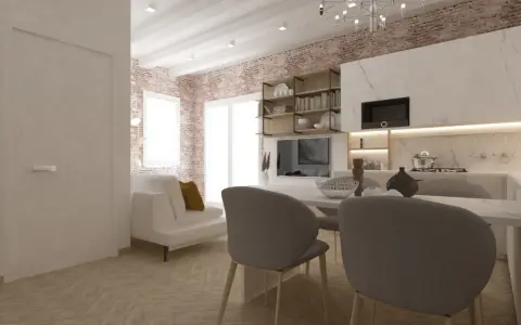 Arredare monolocale con stile: divano bianco, cucina moderna, mattoni a vista e tavolo da pranzo.
