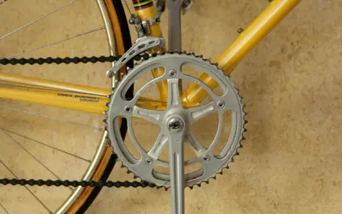 Detaljerad bild av en cykels vevparti och framdrev, perfekt för att visa hur man kan byta framdrev cykel för bättre prestanda.