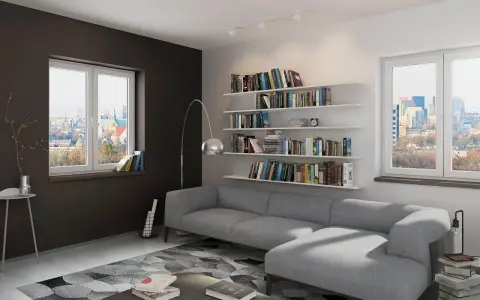 Nowoczesny, biało szary salon aranżacje z szarą kanapą, regałami pełnymi książek i widokiem na miasto.