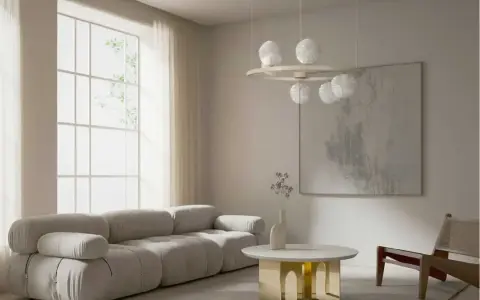 Nowoczesny salon z szarą sofą, okrągłym stolikiem i lampą z kulistymi kloszami w stylu art deco.