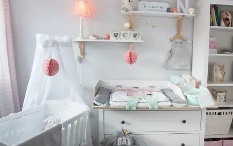 Eine liebevoll eingerichtete Hemnes Wickelkommode mit Babykleidung, Spielzeug und Deko.