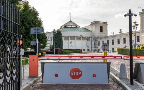Brama wjazdowa do Sejmu, symbolizująca immunitet poselski, z barierą i znakiem STOP.